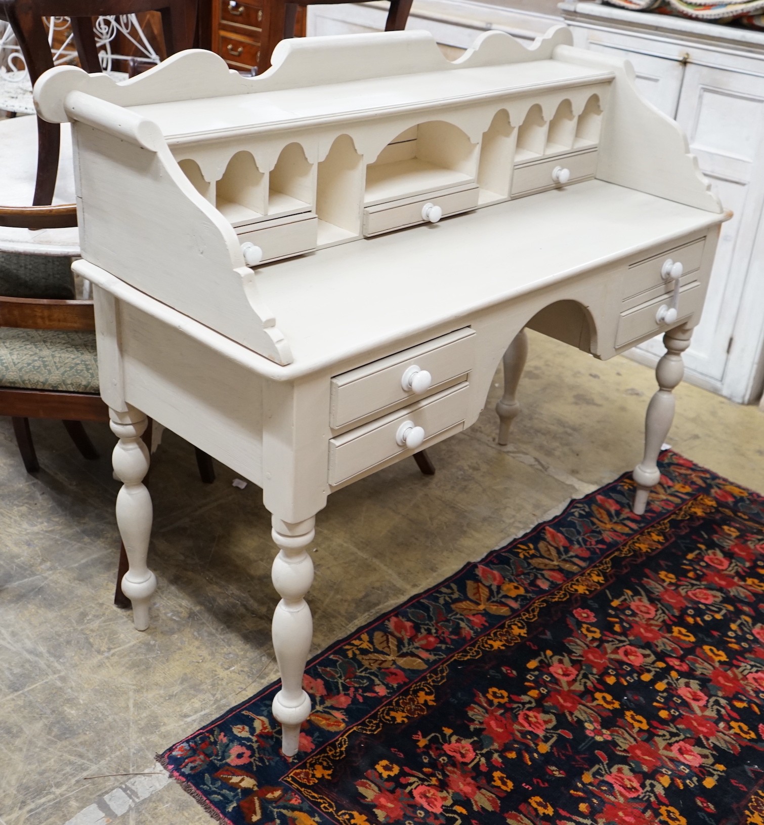 A Victorian style painted pine kneehole dressing table, width 128cm, depth 52cm, height 109cm